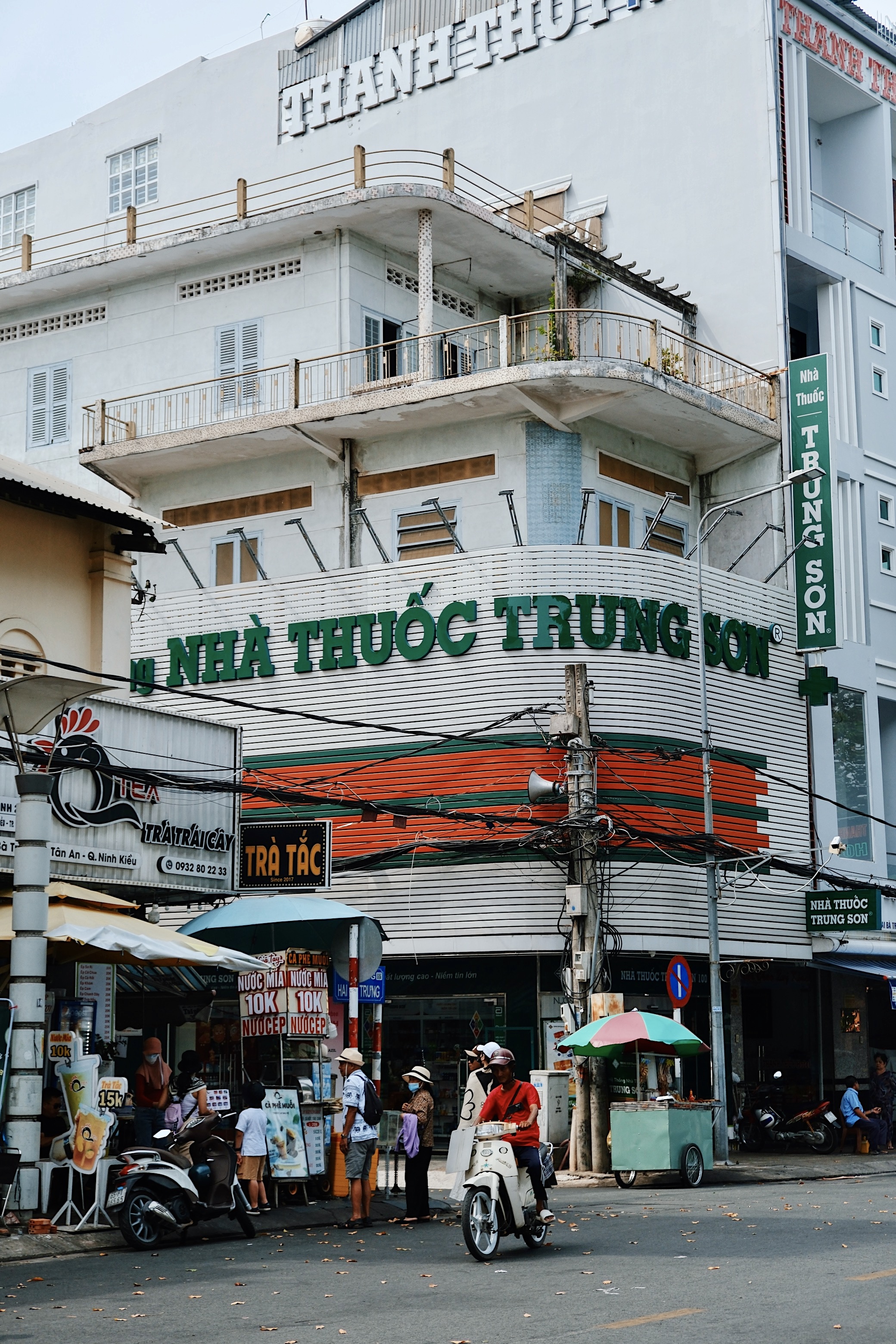A pharmacy in Can Tho using a huge brise soleil to showcase its branding, blending functionality with Vietnamese modernism.