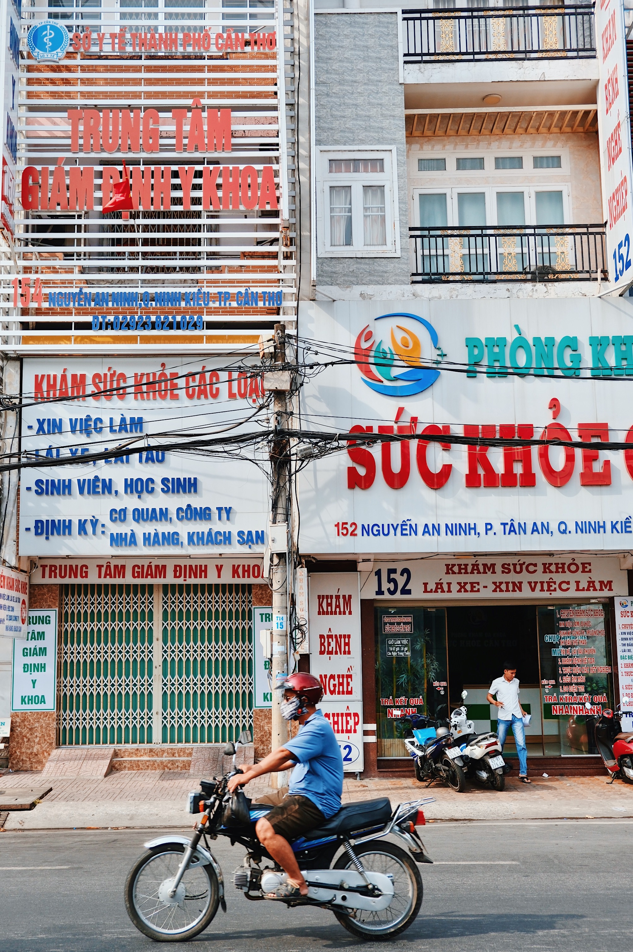 Modernist pharmacies in Can Tho (located in the Mekong Delta of Vietnam) with bold, vibrant commercial signs.