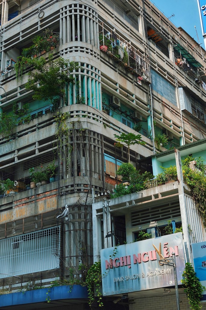 A residential building in Can Tho with light, airy modernist elements like double-wall balconies and vertical louvers.