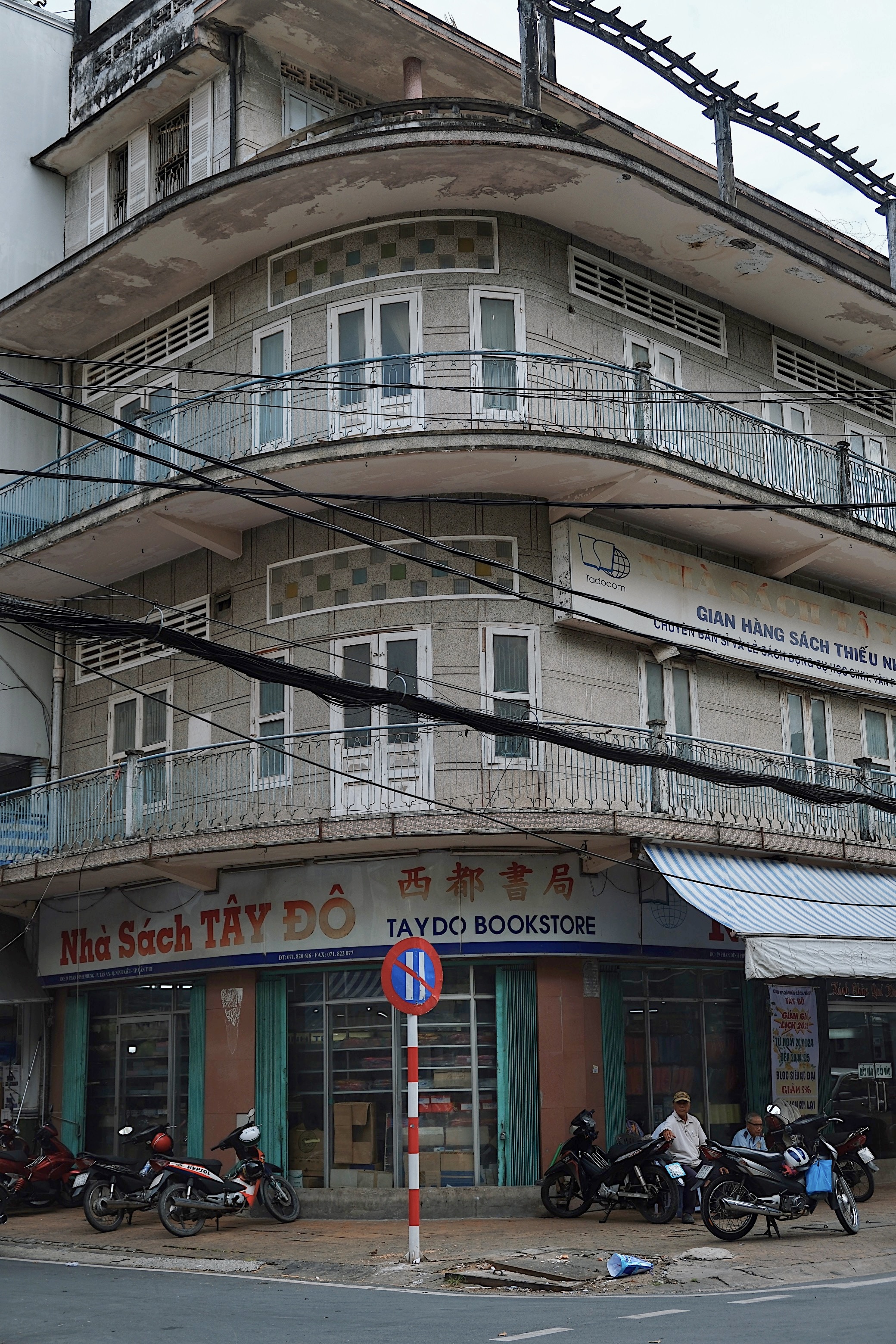Mid-century modernist shophouses in Can Tho, integrating passive cooling techniques with decorative sun-shading panels.