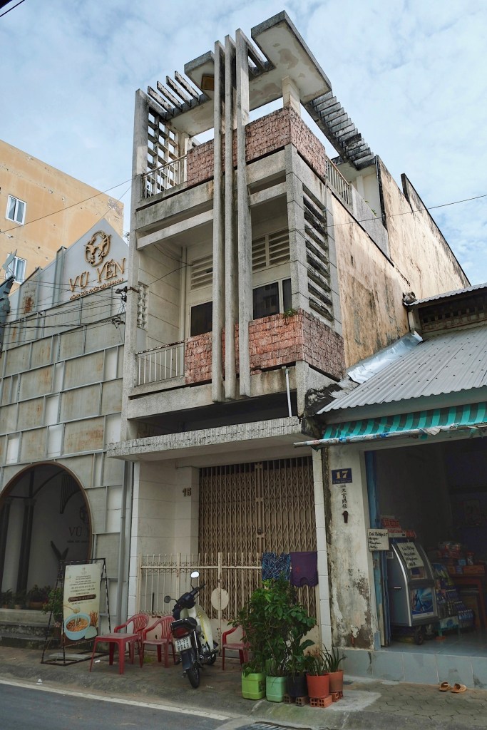 A modernist shophouse in Can Tho featuring concrete brise soleils, pergolas, and louvers designed for shade and ventilation.