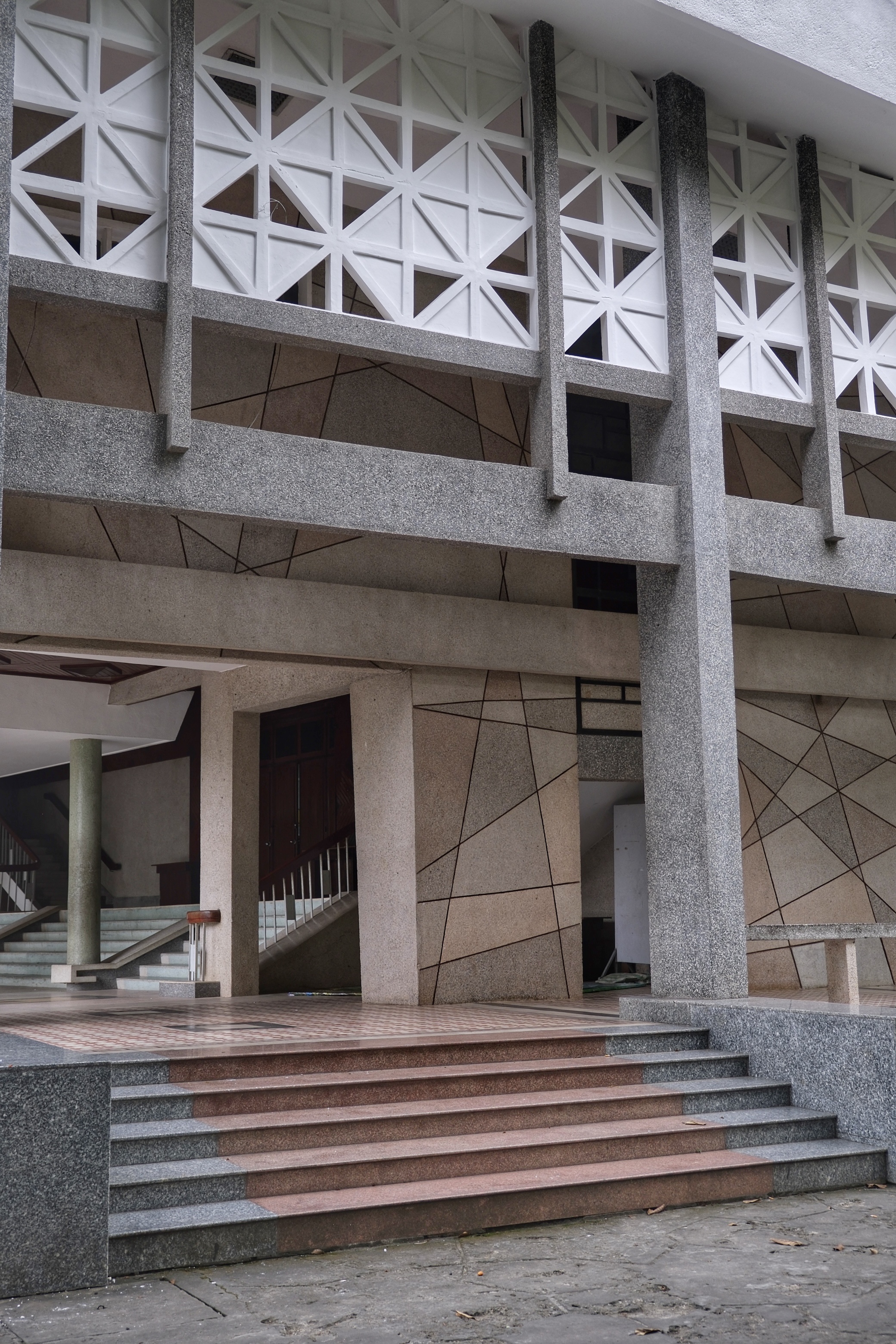 Brutalist public buildings in South Vietnam, featuring modular concrete elements, large open-air corridors, and deep-set sun-shading techniques.