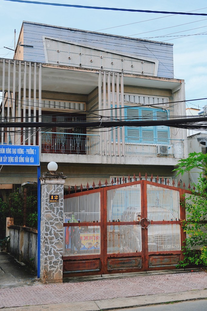 A villa in Vinh Long, showcasing an expansive double-wall balcony elegantly paired with vertical brise soleils, blending architectural sophistication with functional design.