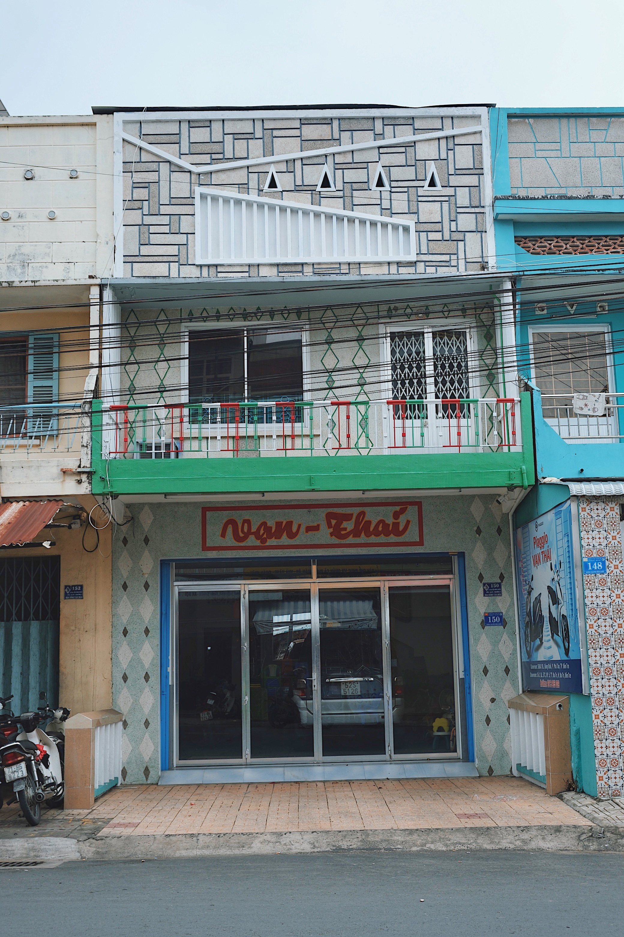 Brutalist and modernist architecture in Ben Tre, Vietnam, with cantilevered terraces, ornamental ventilation blocks, and passive cooling features.