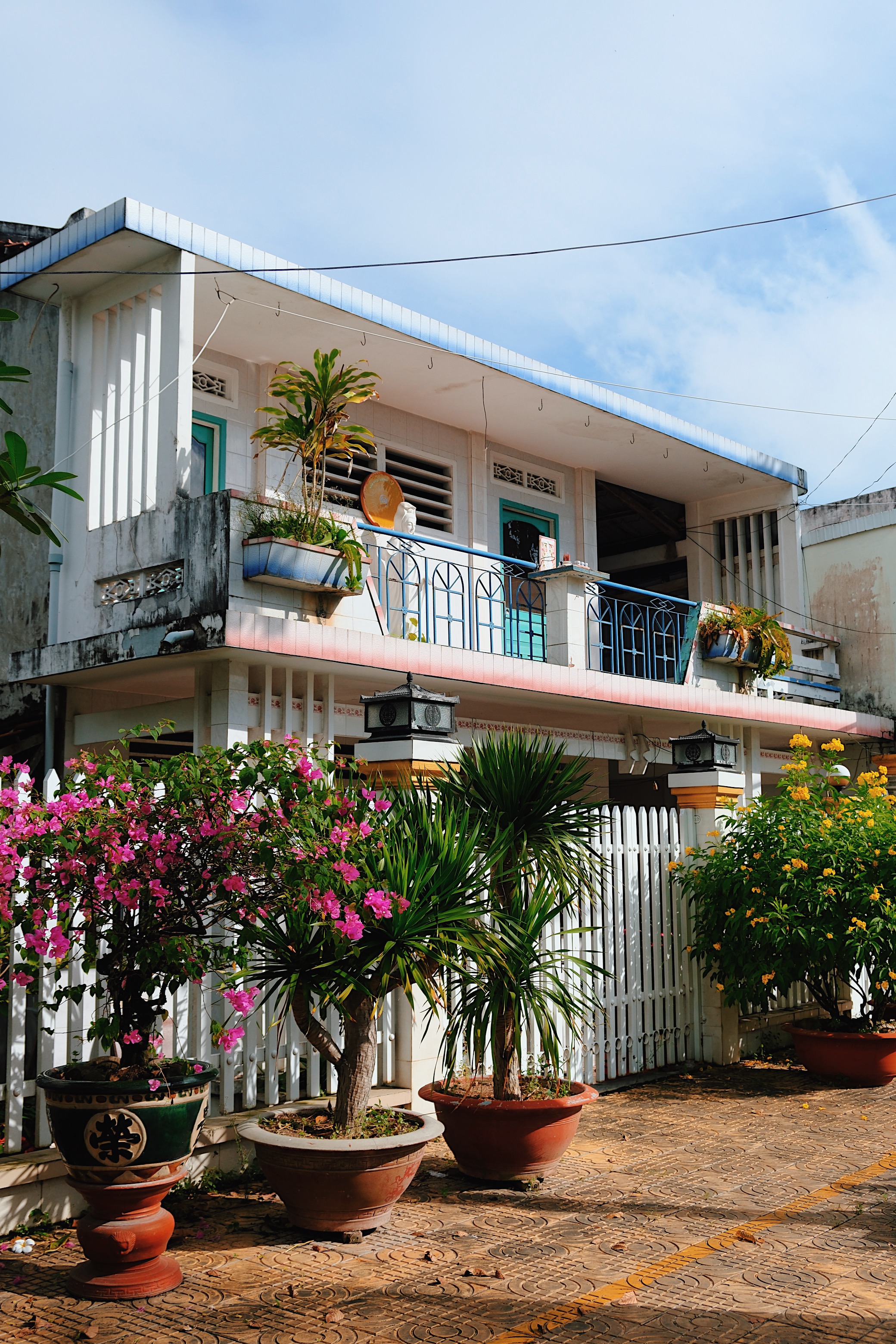Brutalist and modernist architecture in Ben Tre, Vietnam, with cantilevered terraces, ornamental ventilation blocks, and passive cooling features.
