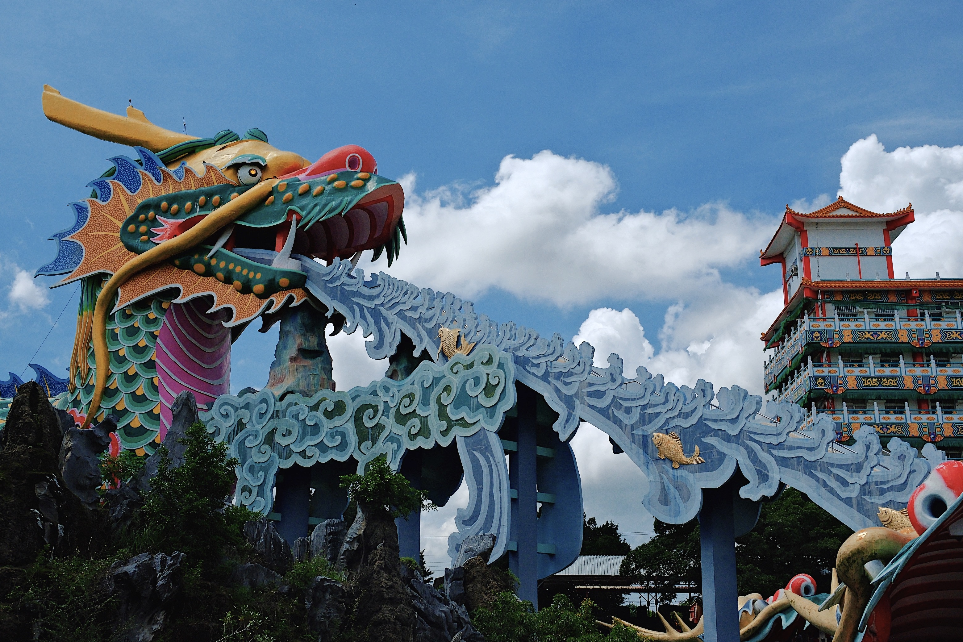 The vibrant Madou Daitian Temple in Tainan, featuring an enormous blue dragon sculpture forming a bridge, blending Taoist mythology with modern design.