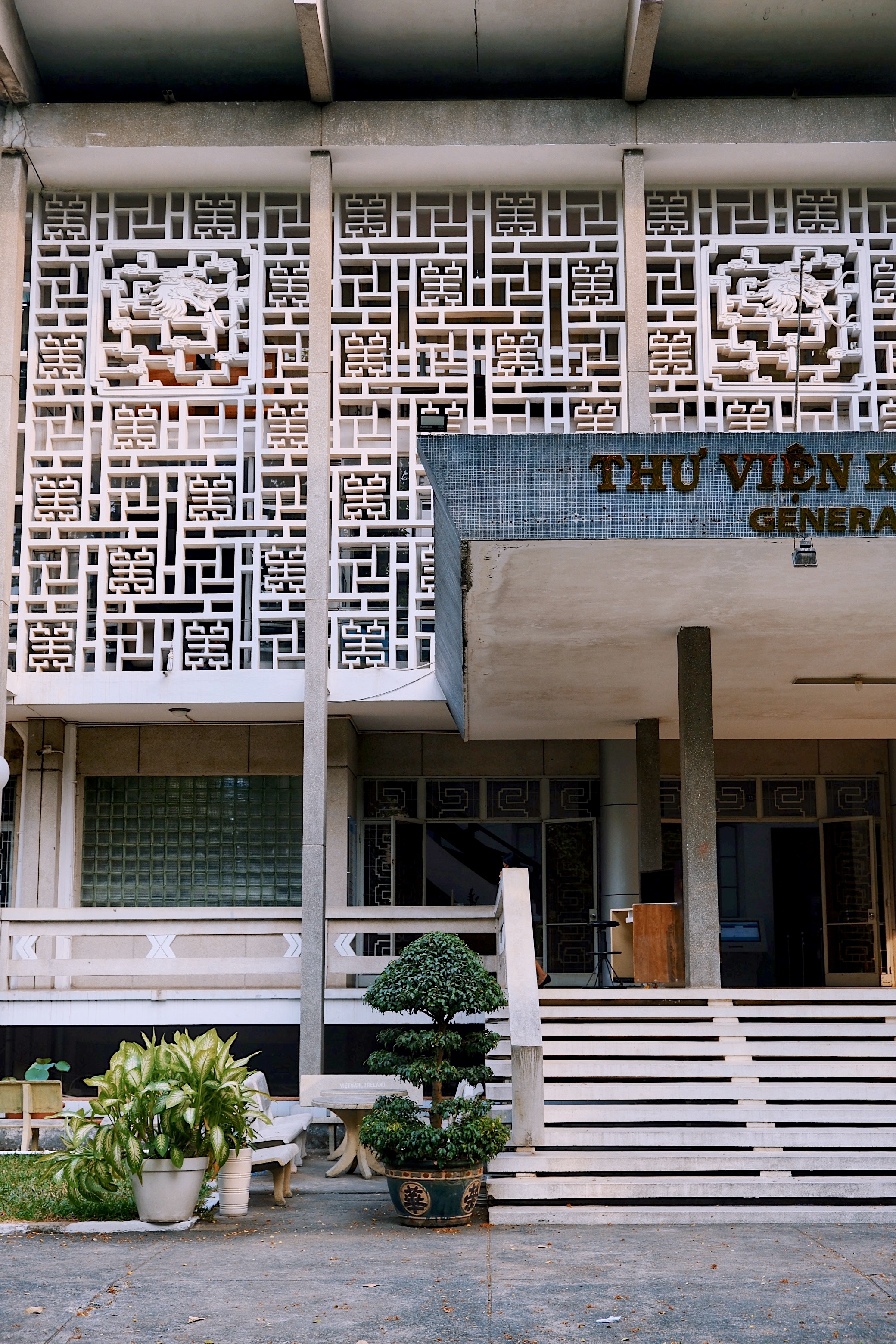 Detail of the brise-soleil and entrance of Vietnam’s General Sciences Library, highlighting geometric concrete patterns in Southern tropical modernism.

